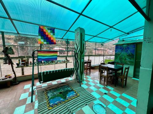クスコにあるCocaRunaWasiのプールとテーブルと青い屋根のあるパティオ