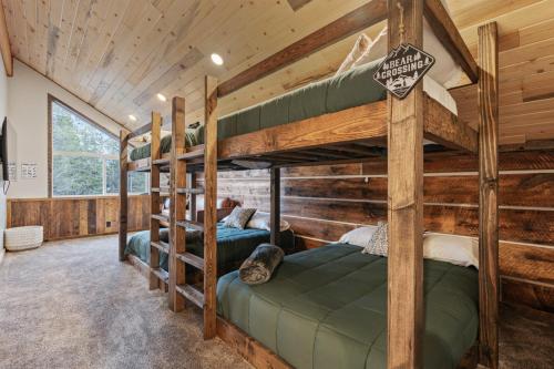 a bedroom with two bunk beds in a cabin at Timber and Tin in Island Park
