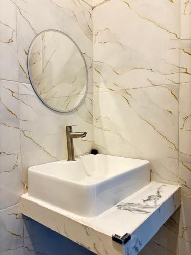 a bathroom with a sink and a mirror at Hostel Labuan ORA in Labuan Bajo