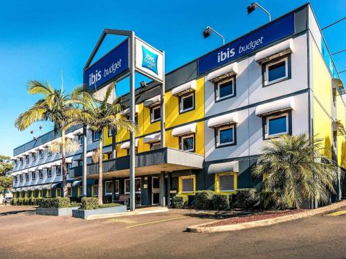 a hotel with a sign on the front of it at ibis Budget - Enfield in Sydney