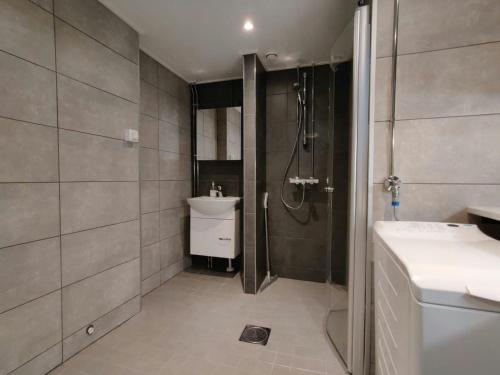 a bathroom with a shower and a toilet and a sink at Central and Spacious Apartment for 11 in Kemi