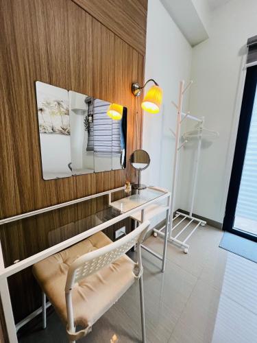 a room with a desk and a chair and a mirror at MOA GRAND STAY Suite 03 Spacious Unit ! in Manila