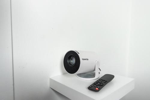 a white heater and a remote control on a shelf at Charming 3 Bed House with Garden in Bickley