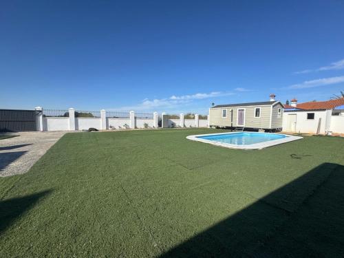 a large lawn with a pool on top of it at Coral Bungalow in Isla Canela