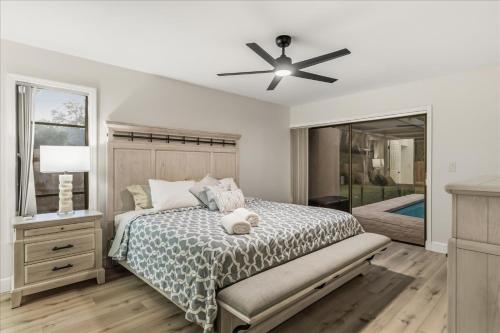 a bedroom with a bed and a ceiling fan at Dream Home Family Retreat 4BR Near the Gulf in Palm Harbor