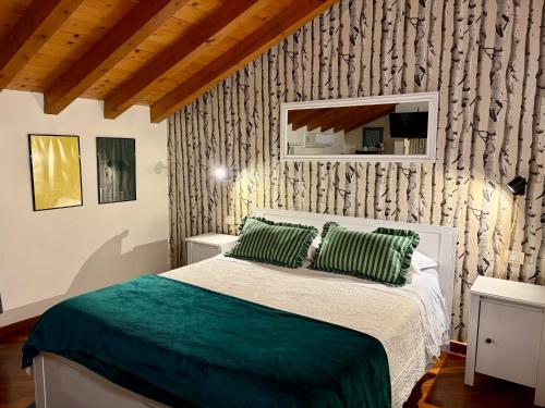 a bedroom with a bed with green pillows at B&B La Borasca - Rooms in Casalpusterlengo