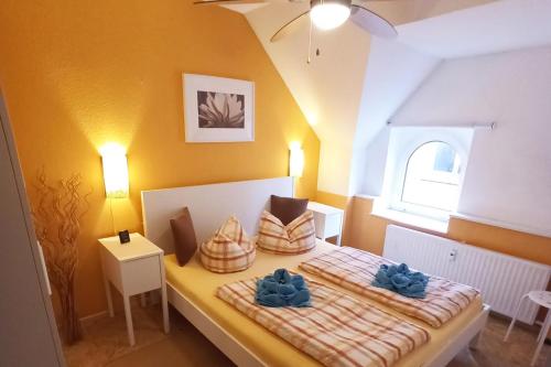 a small bedroom with two beds with blue pillows at 2 Bed Apt Sleeps 5 - Rooftop Terrace Wifi in Cochem