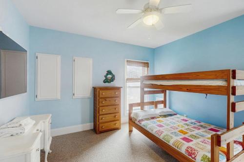 a bedroom with a bunk bed and a dresser at Sapphire Winds #13-R in Rodanthe