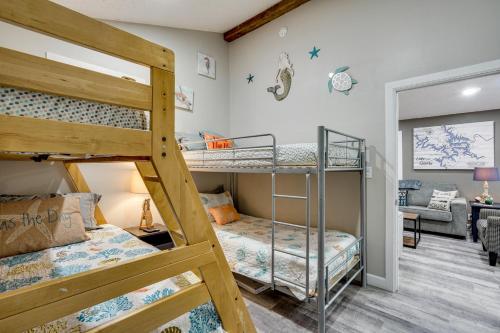 a bedroom with two bunk beds and a living room at Lakefront Fun in Sunrise Beach! Pet-Friendly Home! in Sunrise Beach