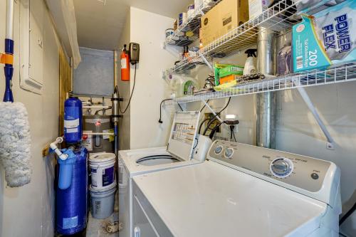 a laundry room with a washing machine and shelves at Lakefront Fun in Sunrise Beach! Pet-Friendly Home! in Sunrise Beach
