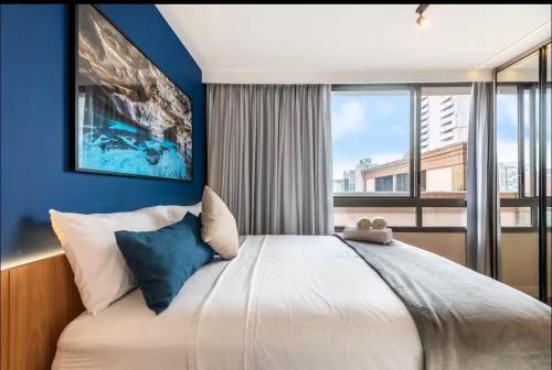 a bedroom with a large bed with a large window at On Domingos By Bstay in Sao Paulo