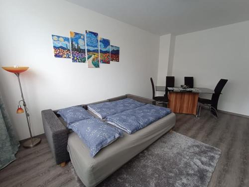 a bedroom with a bed with blue pillows on it at Apartment Arte in Graz
