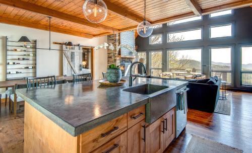 a kitchen with a large counter top and a living room at Owls Nest in Seven Devils