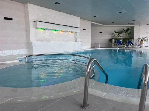a large swimming pool in a hotel room at Stunning Panoramic Sea & Marina Skyline View in Dubai