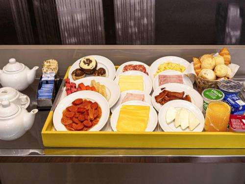 a tray of food with different types of food at Mercure Sao Paulo Vila Olimpia in Sao Paulo