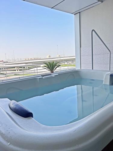 a bath tub with a view of the beach at Stunning Panoramic Sea & Marina City Skyline View in Dubai