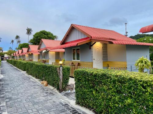 a row of houses with red roofs at Phi Phi Ba Kao Bay Resort in Phi Phi Don