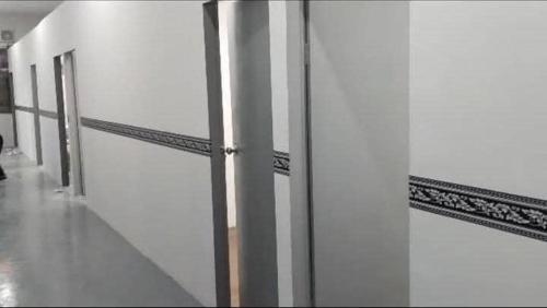 a row of white walls in a hallway at D-Bayu Motel in Papar
