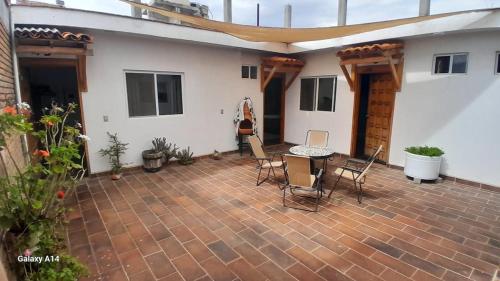a patio of a house with a table and chairs at Casa Bella Vizcaína in Mineral de Pozos