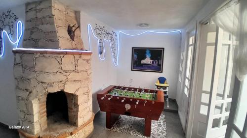 a room with a pool table in front of a fireplace at Casa Bella Vizcaína in Mineral de Pozos