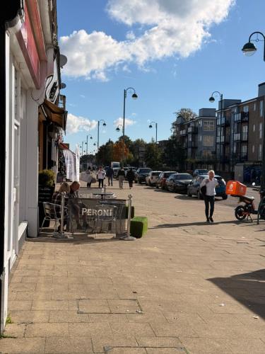 a person walking down a street next to a building at Shirley Guest Flat 1 in Southampton