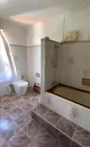 a bathroom with a toilet in a room at FINRAH Rental Property Ltd in Curepipe