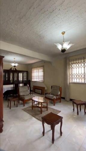 a living room with couches and tables and a ceiling at FINRAH Rental Property Ltd in Curepipe