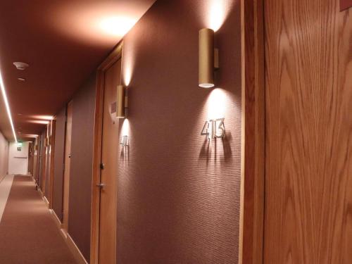 a hallway with a row of halls with numbers on the wall at Novotel Mexico City Santa Fe in Mexico City