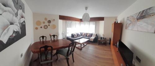 ein Wohnzimmer mit Tisch und Couch in der Unterkunft Apartamentos Maliayo A in Villaviciosa