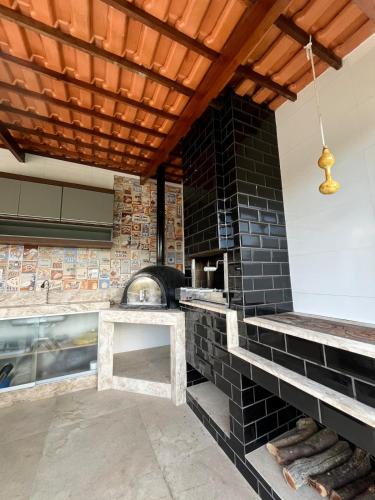 a kitchen with a brick wall and a stove at Casa Vovó Vadé in Palmeiras
