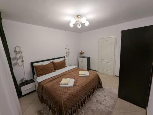 a bedroom with a bed with two towels on it at Apartament kilometrul 0 Bacau in Bacău