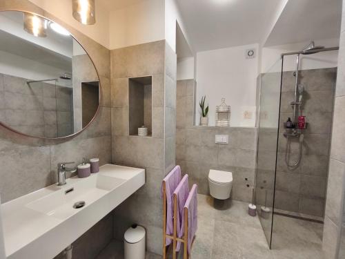 a bathroom with a sink and a shower at Apartment Stone Pearl in Kaštela