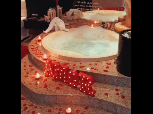 a bath tub with a dog in it with lights at Exos Castelinho Motel in Concordia