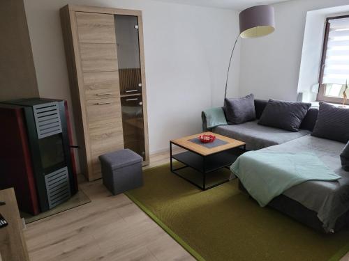 a living room with a couch and a table at Ferienhaus Klara in Schweich