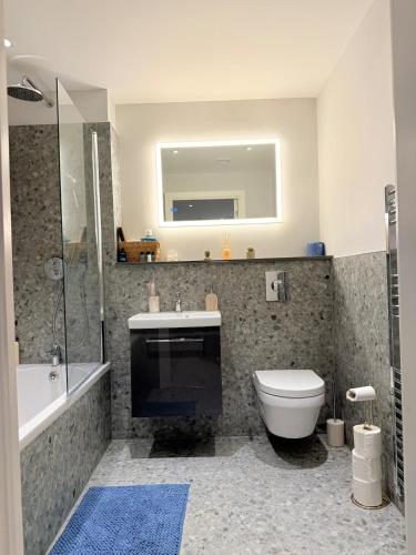 a bathroom with a toilet and a sink and a shower at West London Residences - Private Terrace - Opposite Piccadilly Line 20min SOHO Oxford Street in Uxbridge