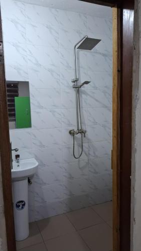 a bathroom with a shower and a sink at Rennyshouse 3 Bedroom Apartments in Alimosho