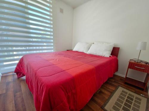 Ένα ή περισσότερα κρεβάτια σε δωμάτιο στο Departamento en Pucon