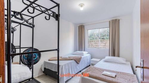 a bedroom with two beds and a window at Apartamento em Sao Jose proximo a Arena Opus in Estêvão