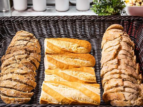 three slices of bread in a wicker basket at Hotel ibis Lisboa Alfragide in Lisbon