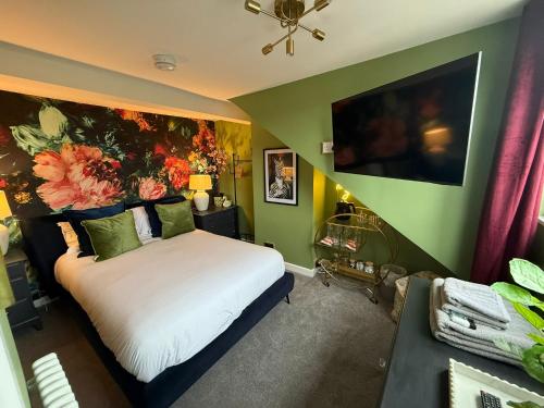 a bedroom with a bed with a flower painting on the wall at Unique Shrewsbury Rooms in Shrewsbury