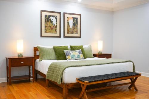 a bedroom with a bed with two night stands and two lamps at 617 Neptune Way in Demere Park