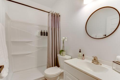 a bathroom with a toilet and a sink and a mirror at Wooded Cottage - 3 Mi to Clemson University in Clemson