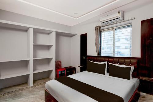 a bedroom with a bed and a window at HOTEL O STAY INN RESIDENCY in Upal