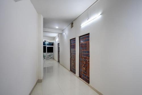 a hallway with glass doors in a building at SPOT ON New Hamsafar in Jhūsi