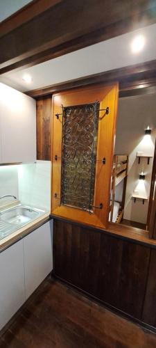 a kitchen with a cabinet filled with wine bottles at Appartamento in Residence - Parco Nazionale d'Abruzzo in Pescasseroli