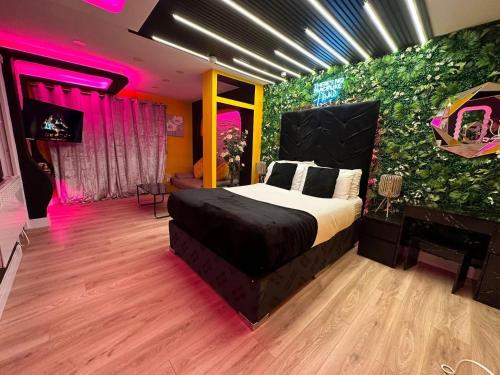 a bedroom with a bed and a green wall at Jacuzzi Suites in Halifax