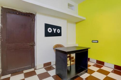a room with a door and a sign on the wall at Hotel O Rose Inn in Bālianta