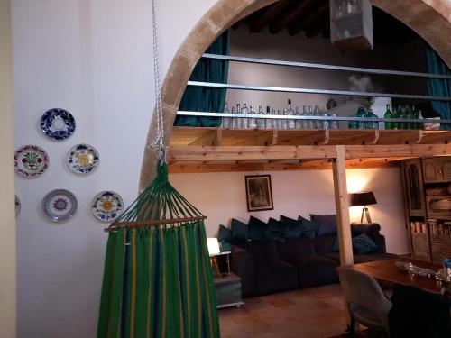 a living room with a green broom on the wall at Traditionelles Dorfhaus Malona in Malona Village