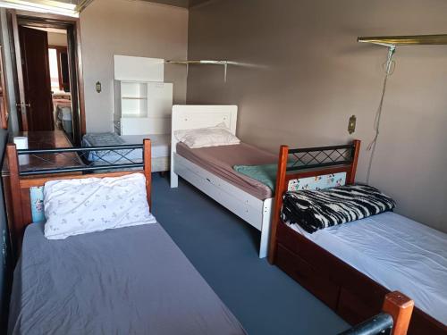 a room with two bunk beds in it at Mamma's Hostel e Pousada in Caxias do Sul