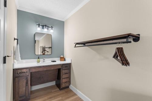 a bathroom with a sink and a mirror at Branson Falls Lodge in Branson